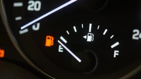 Close-up shot of the empty gas gauge on the car dashboard