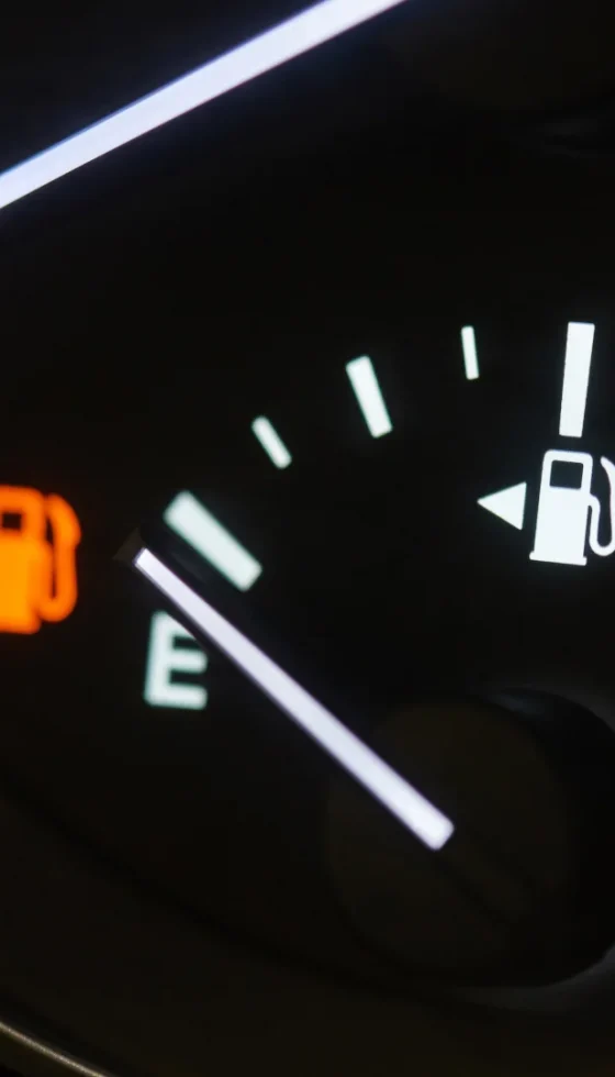 Close-up shot of the empty gas gauge on the car dashboard