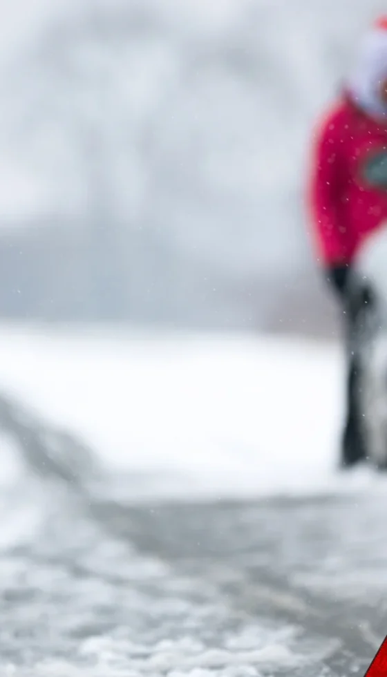 Winter snowy road and car breakdown and emergency warning triangle on road behind vehicle