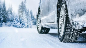 Close-up view of tires on the snow covered road