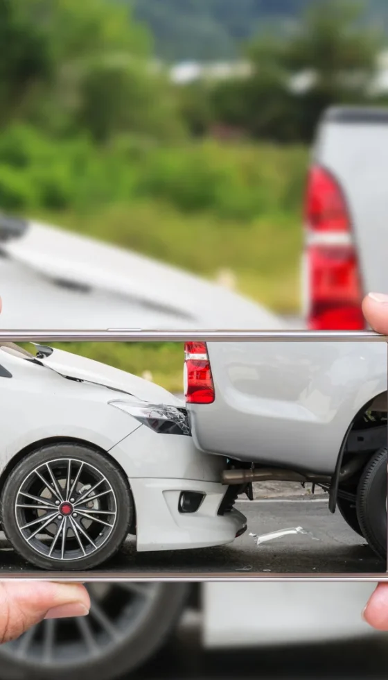 Woman holding smartphone and taking photo of her car accident