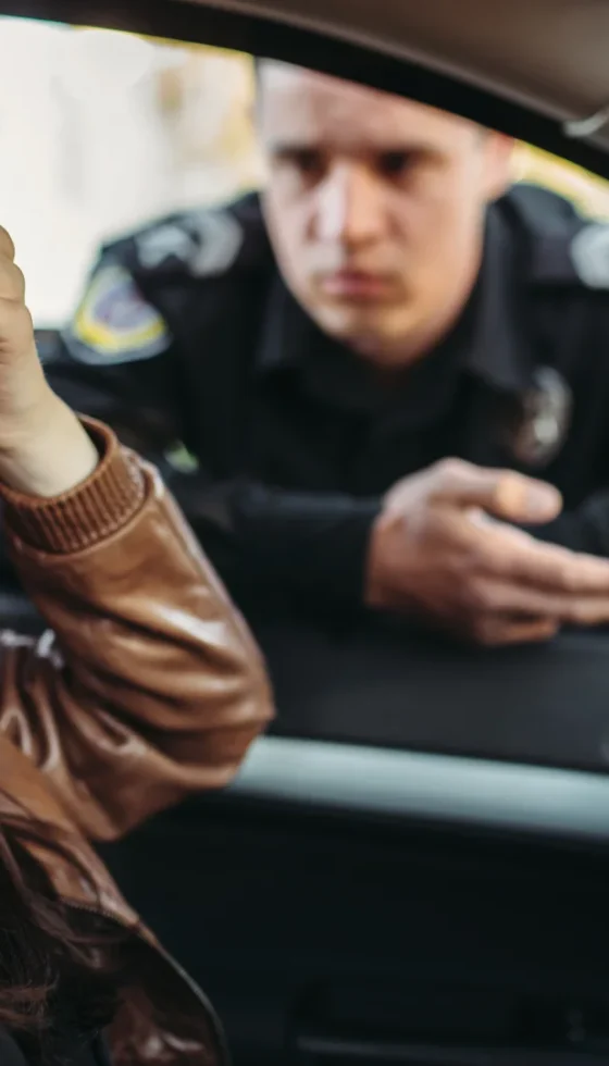 Male cop in uniform stopped female driver and hand holding her forehead in frustration