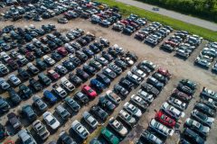 A large junk yard with salvaged and junked cars - cheap car insurance.