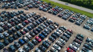 A large junk yard with salvaged and junked cars - cheap car insurance.