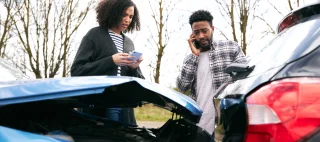 Woman and man looking at their cars in a rear-end collision