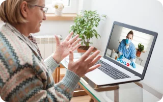 woman discussing medical issues online with her doctor on a laptop computer
