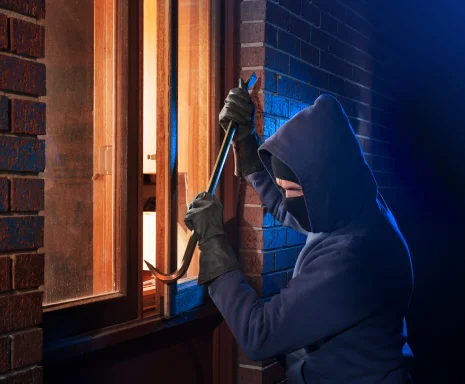 Burglar Using Crowbar To Break Into a House at night