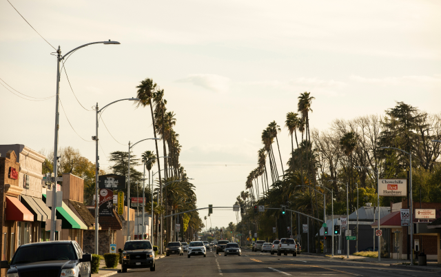 Late afternoon sunlight shines on the buildings along Robertson Blvd in downtown Chowchilla, Madera County – Madera, cheap car insurance in California