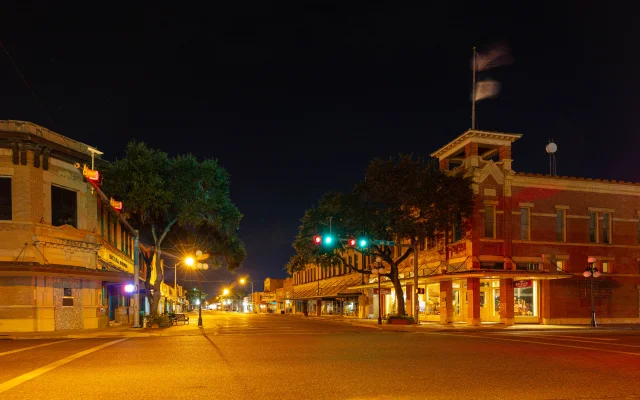 View down E Kleberg Ave at night, Kingsville, Texas, USA – Kingsville, cheap car insurance in Texas