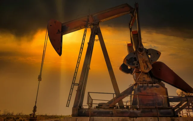Hard working Pump Jack sunset in Midland Texas Permian Oil fields.
