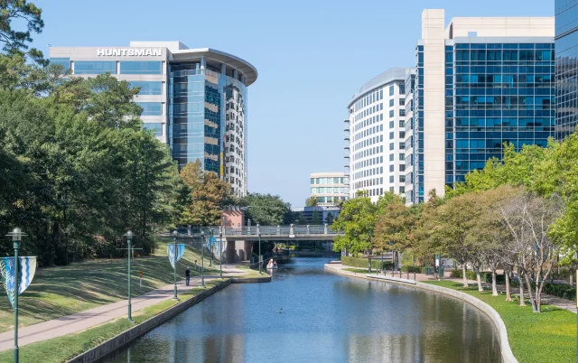 River flowing through urban business district in The Woodlands, Texas, USA – The Woodlands, cheap car insurance in Texas